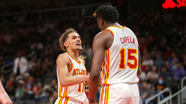 Trae Young motivates Clint Capela.